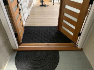 an open door with a rug in a hallway at CA2 House SoCal Oasis Newly Renovated Game Room in La Palma
