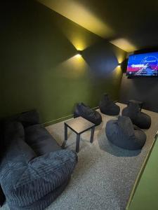 a living room with a couch and a tv at Elevated Escape in Seabrook