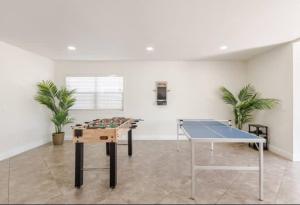 a ping pong table in a room with a ping pong ball at CA3 House Spacious SoCal Home for Groups in La Palma