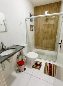 a bathroom with a toilet and a shower and a sink at Casa de Praia Frances in Marechal Deodoro