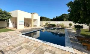 a swimming pool in the backyard of a house at Casa de Praia Frances in Marechal Deodoro