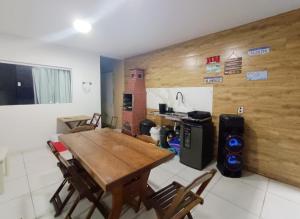 a dining room with a wooden table and chairs at Casa de Praia Frances in Marechal Deodoro