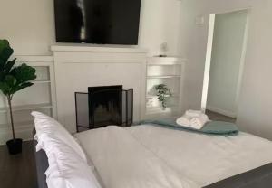 una camera con letto, camino e TV di CA5 House Cozy 3BR in Azusa ad Azusa Altre 33 foto