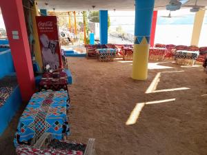 a room with tables and chairs in a building at Manar Hause & Nubian studio in Aswan