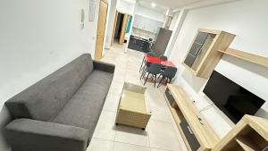 a living room with a gray couch and a kitchen at Buena Vista in Arinaga