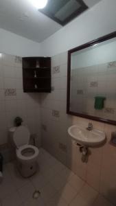 ein Badezimmer mit Toilette und Waschbecken in der Unterkunft Casa La Carmela in Cota
