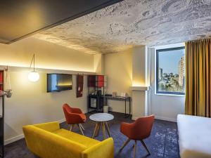a living room with a couch and chairs and a table at ibis Baku City in Baku