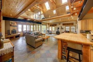 a large living room with a table and a couch at Lake Pend Oreille Oasis Home with Hot Tub and Games in Sagle