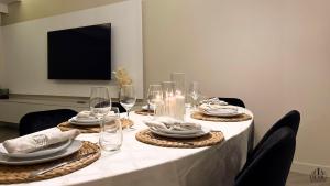 a table with plates and wine glasses on it at Serenity in Praia