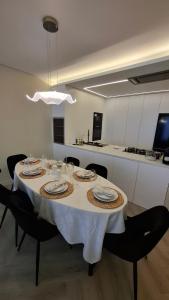 a dining room table with a white table cloth on it at Serenity in Praia