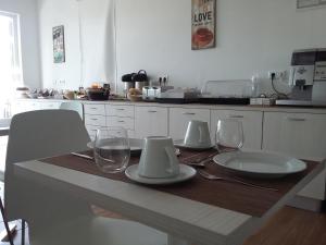 a kitchen with a table with plates and glasses on it at Tavira Monte in Tavira