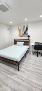 a bedroom with a bed and a desk in it at PALO ALTO MASTER with private bathroom and private entry , near Stanford in East Palo Alto