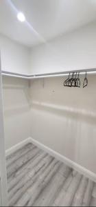 a white room with a shelf with glasses on it at PALO ALTO MASTER with private bathroom and private entry , near Stanford in East Palo Alto