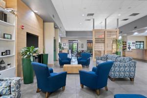 a waiting room at a hospital with blue chairs at GreenTree Inn & Suites Phoenix Sky Harbor in Phoenix