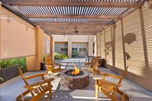 a patio with chairs and a fire pit at GreenTree Inn & Suites Phoenix Sky Harbor in Phoenix