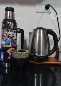 a tea pot and a tea kettle on a counter at Elmosquetal in Villa Yacanto