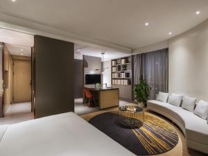 a hotel room with two beds and a desk at Mercure Nanjing Olympic EXPO in Nanjing +31 photos