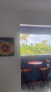 a painting of a table and chairs next to a window at Cantinho da Giza-próx à praia em JP in João Pessoa