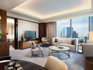 a living room with a couch and a table at Fairmont Chengdu in Chengdu