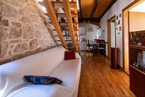 a bed in a room with a stone wall at Apartments by the sea Stari Grad, Hvar - 22052 in Stari Grad