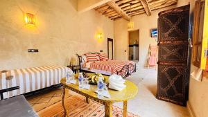 a living room with two beds and a table at Nana Diafa - Luxury Stay in Zagora in Zagora