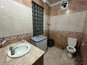 a bathroom with a sink and a toilet at Villa Sakinah Ciwidey in Bandung +22 photos