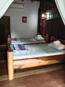 Katil atau katil-katil dalam bilik di Vasana RuanThai Homestay วาสนา เรือนไทย โฮมสเตย์