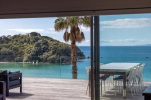 Un comedor con vista al mar en Waikare House - Above Oneroa Bay, en Waiheke Island