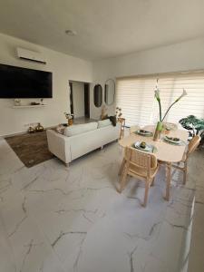a living room with a couch and a table at Modern House with Private Pool in Punta Cana in Punta Cana