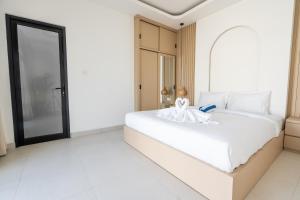 a bedroom with a large white bed in a room at Kaya Villa Pererenan in Munggu +39 photos
