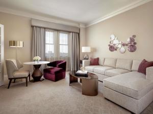a living room with a couch and a table at Fairmont Hotel Macdonald in Edmonton