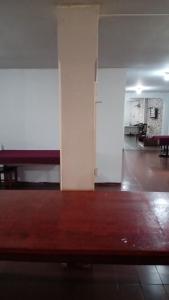 an empty room with a wooden floor and a white wall at Hotel paraiso in Jataí
