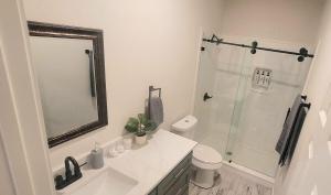 a bathroom with a sink and a shower with a mirror at Simon's casitas! in McGregor