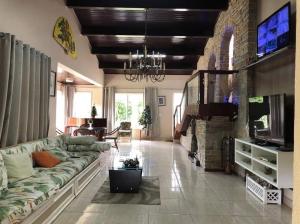 a living room with a couch and a fireplace at Pousada Monte Libano Petropolis in Nogueira