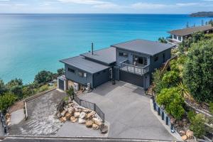 an aerial view of a house with the ocean at Oceanview Oasis - Home & Apartment in Tairua