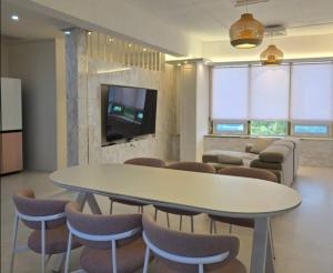 a meeting room with a table and chairs and a tv at Wine B Haus Daejeon in Daejeon
