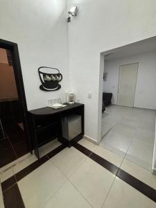 a room with a black table in the middle of a room at AlcBalam Room in Bacalar +1 photo
