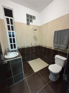 a bathroom with a toilet and a sink at AlcBalam Room in Bacalar