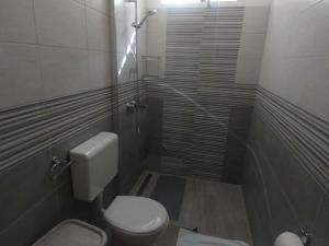a small bathroom with a toilet and a shower at Four Bedroom Holiday Home With Terrace & Sea View in Poljica