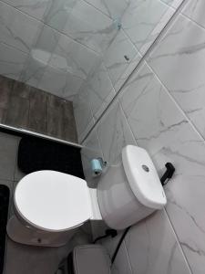 a bathroom with a white toilet in a room at Sítio Bela Vista in Angra dos Reis