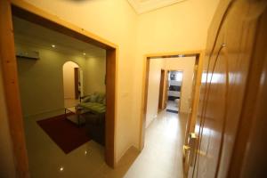 a view of a living room with a couch and a hallway at Z alal Hotel in Jeddah +2 photos