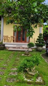 a house with a tree in front of it at Ondokhouse Taro in Gianyar