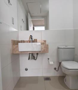 a bathroom with a sink and a toilet at Central apartment in Asunción in Asuncion
