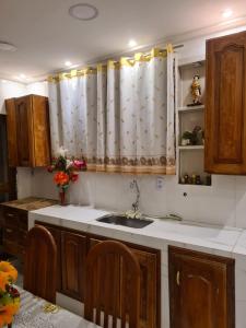 a kitchen with a sink and a shower curtain at Beautiful House - COP30 in Belém