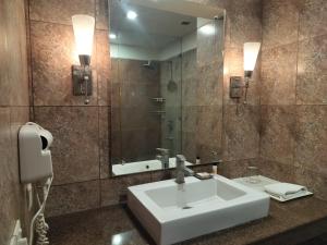 a bathroom with a white sink and a mirror at Stellar Resorts By Bel-La Monde, Rajokri, Near IGI Airport, Delhi in New Delhi +48 photos