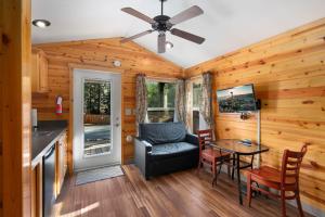 a living room with a table and a chair at Robinhood Village Resort in Union