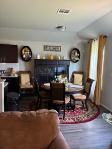 a living room with a table and chairs at Your Honey Bee! Beautiful 2k sf! in Stillwater