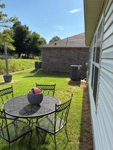 a patio table with a bowl of balls on it at Your Honey Bee! Beautiful 2k sf! in Stillwater