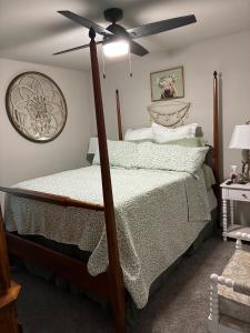 a bedroom with a bed with a ceiling fan at Your Honey Bee! Beautiful 2k sf! in Stillwater