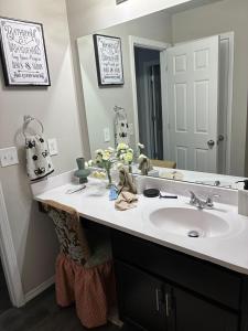 a bathroom with a sink and a mirror at Your Honey Bee! Beautiful 2k sf! in Stillwater +27 photos